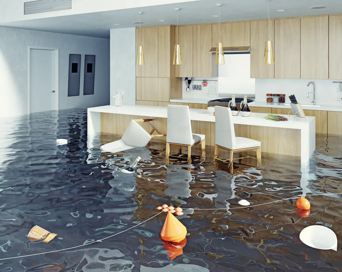 Kitchen flooded with standing water after a supply line failure — an emergency water damage scene