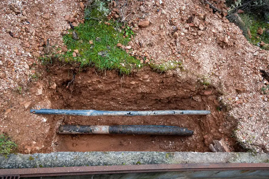 Broken water supply pipes exposed for repair after a burst at a Marana, AZ property