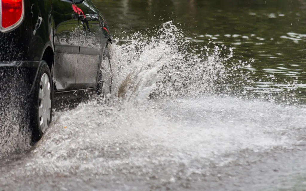 A car stranded in deep monsoon floodwater on an Arizona road — Vekol Wash has repeatedly cut SR-347, Maricopa’s main link to the valley