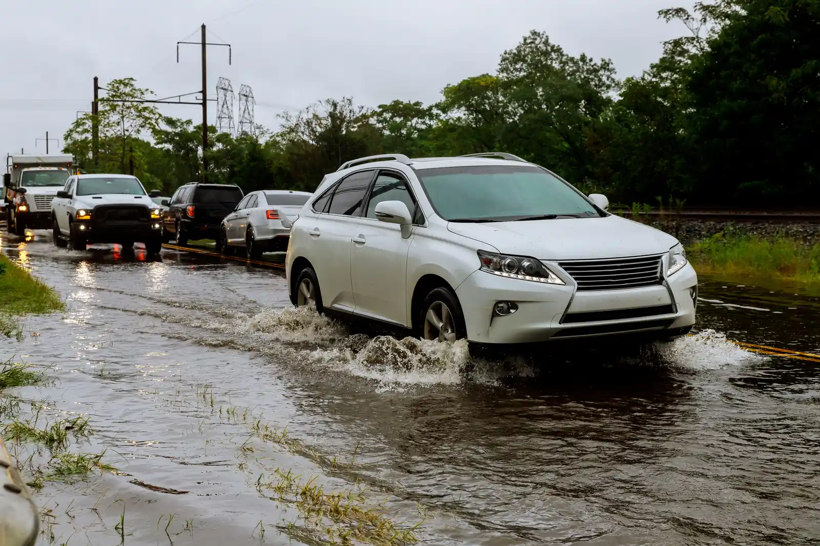 Traffic crossing a flooded roadway during a monsoon storm near Rita Ranch in southeast Tucson, AZ