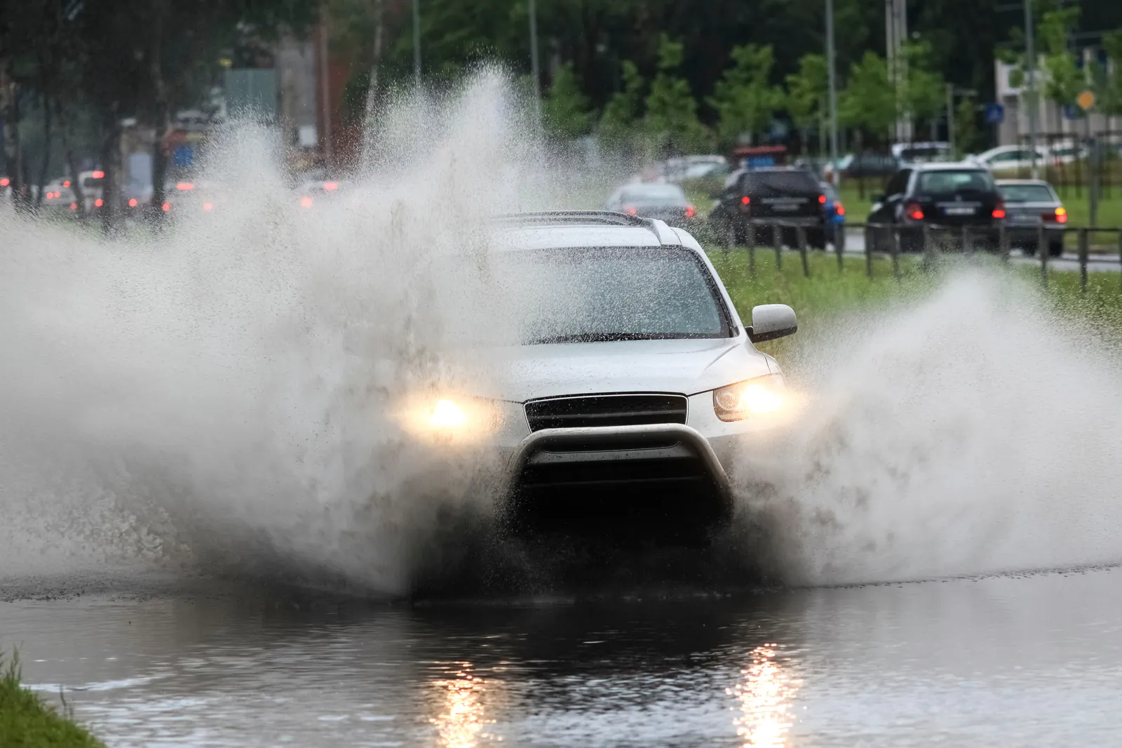 Car pushing through torrential monsoon floodwater near Sahuarita, AZ