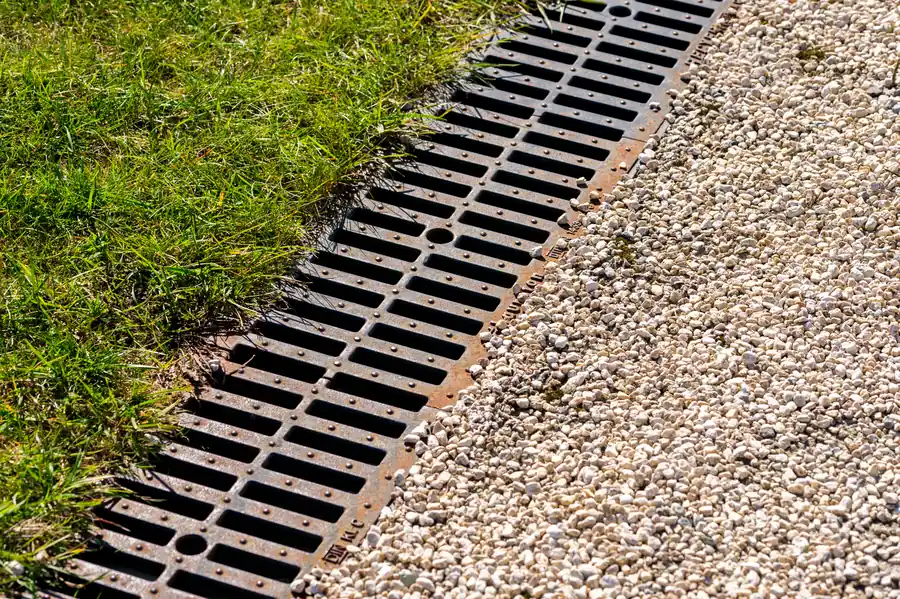 Water pooling over a drain grate during heavy flow, how Marana drains behave when a sewer line blocks or reverses in a storm