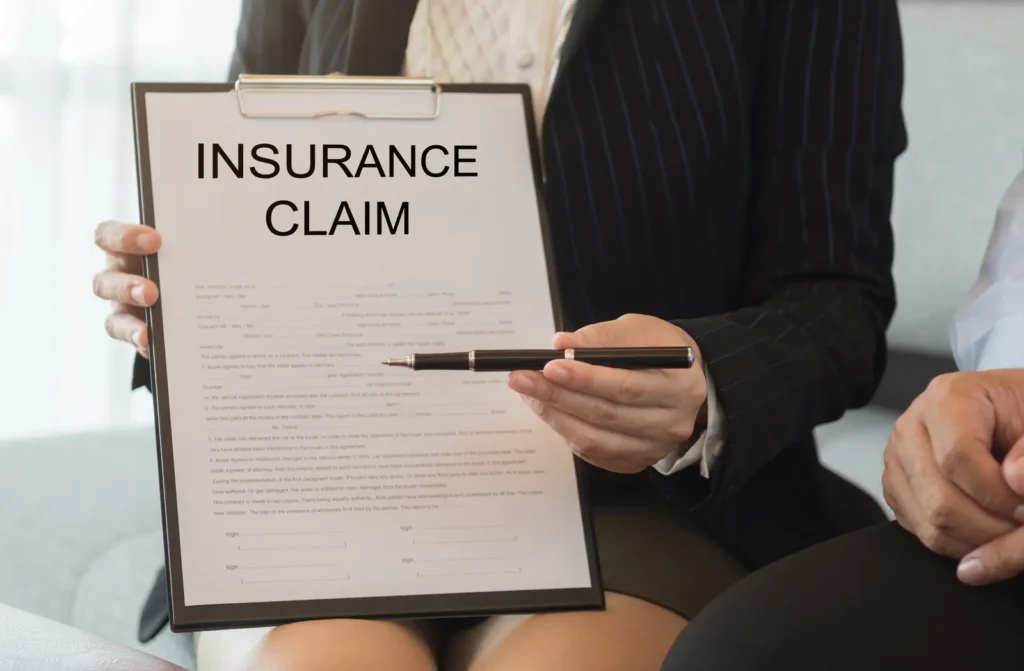 Insurance claim paperwork laid out for review, the documentation stage of a water damage insurance claim for a Tucson home